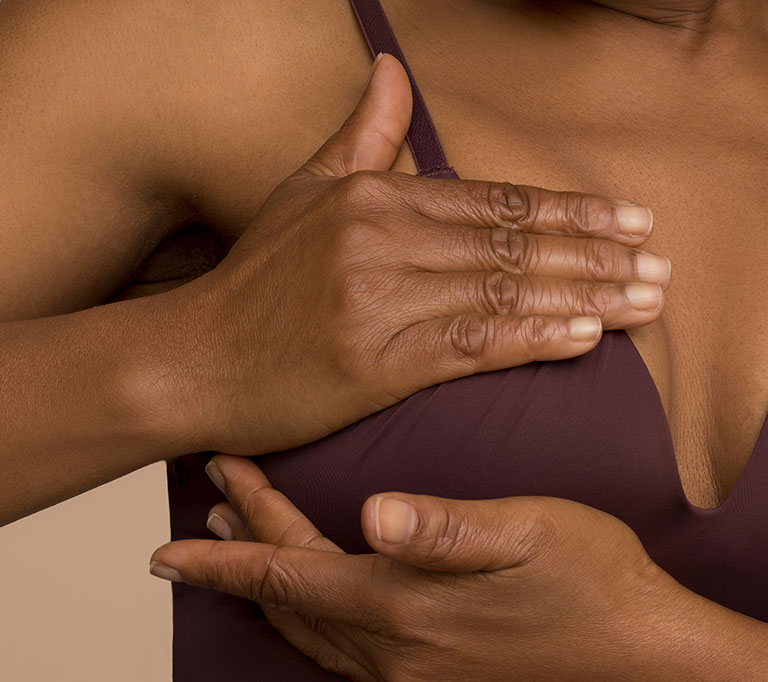 woman checking breasts